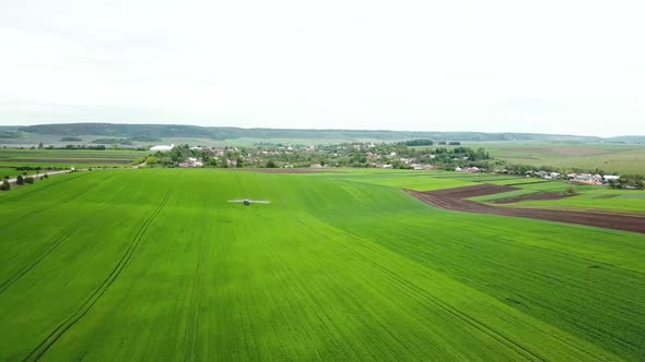 Farm Machinery Spraying Insecticide to the Green Field Agricultural Natural Seasonal Spring Works