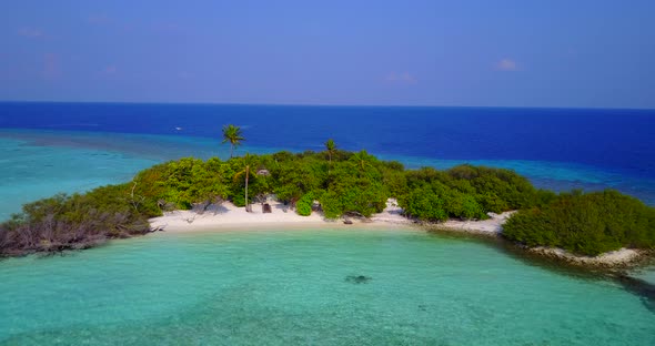 Beautiful birds eye travel shot of a paradise sunny white sand beach and blue water background in 4K