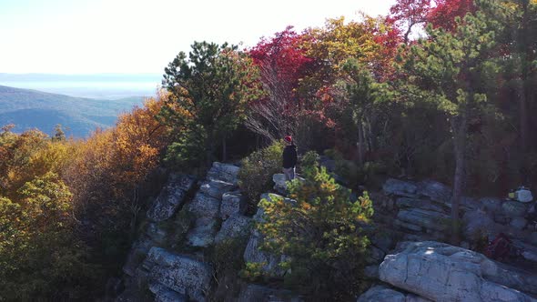 Man stands on Tibbet Knob - West Virginia - Aerial - Autumn