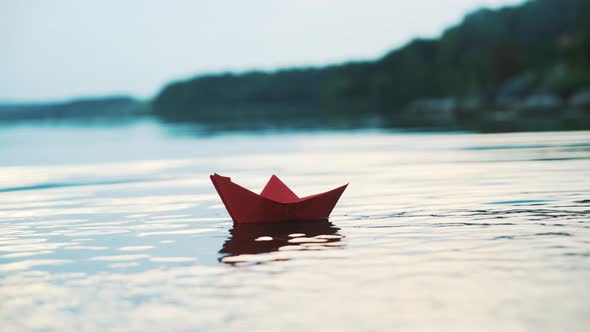 Paper Boat Floating on Water