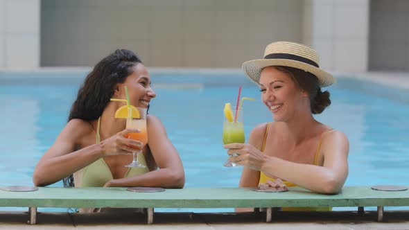 Positive Attractive Multiethnic Diverse Young Girlfriends Drinking Refreshing Juice Cocktail