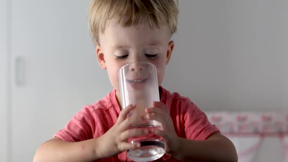 Portrait of Boy Drinking Glass of Water