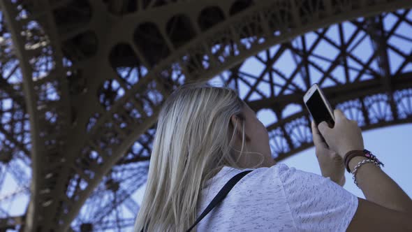 Happy Woman Taking Panoramic Picture Under Eiffel Tower