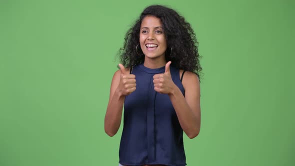 Young Beautiful Hispanic Businesswoman Giving Thumbs Up