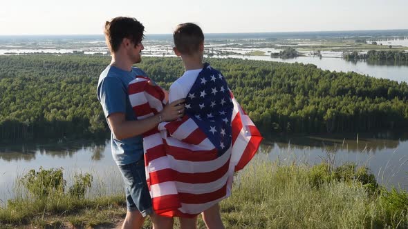 Cute Young Boy and His Father Holding Aloft the American Flag