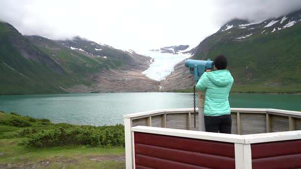 Svartisen Glacier in Norway Tourist girl Looking Glacier