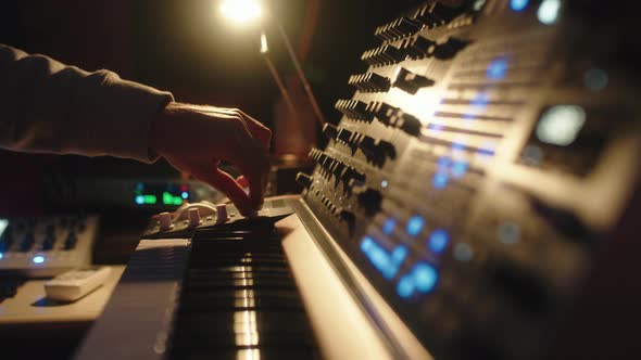 Hands of a Man Sound Engineer are Pressing Buttons on the Console