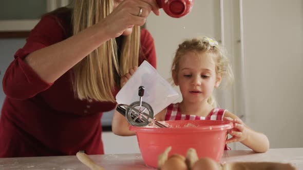 Mother and daughters cooking crepes together