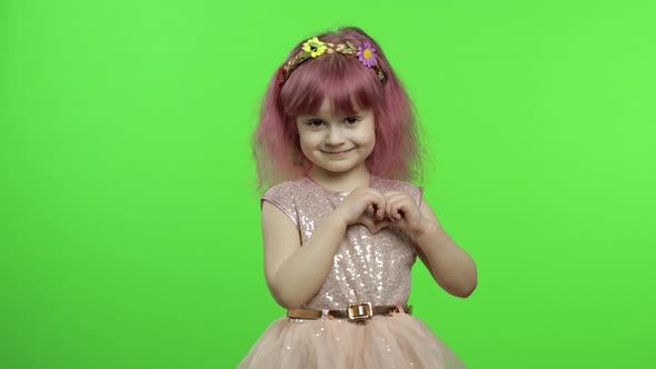 Child Girl Princess Showing Love Heart Sign with Her Hands. Mother's Day Concept