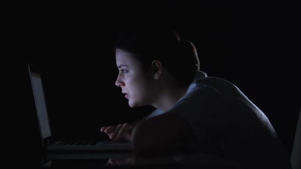 Girl Scrolling Social Networks on Laptop and Smiling