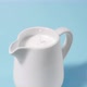 A Drop of Milk Drips Into a Full Milk Jug - VideoHive Item for Sale