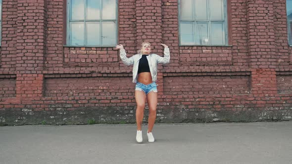 Blonde Woman Dancing Performs Modern Hip-hop Dance Posing Freestyle in Street Urban Stock Footage