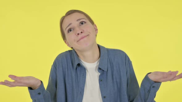 Disappointed Young Woman Reacting Loss on Yellow Background