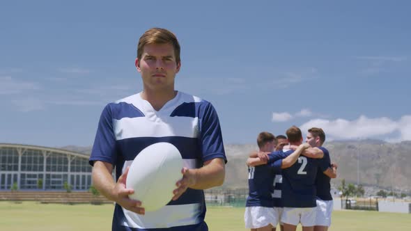 Rugby players standing with ball