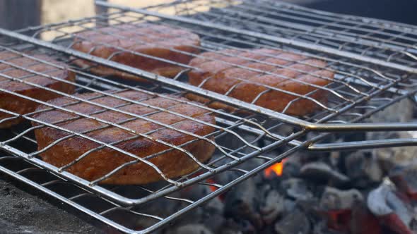 Closeup Fried Fatty Cutlets for a Burger on a Grill