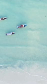 Vertical Video Boats in the Ocean Near the Coast of Zanzibar Tanzania