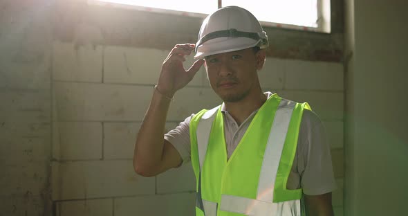 Industrial Engineer Man In Hard Hat Wearing Safety Jacket Working In The Building Construction Site.