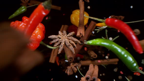 Super Slow Motion Shot of Colorful Seasoning Falling From Behind Camera on Black at 1000Fps
