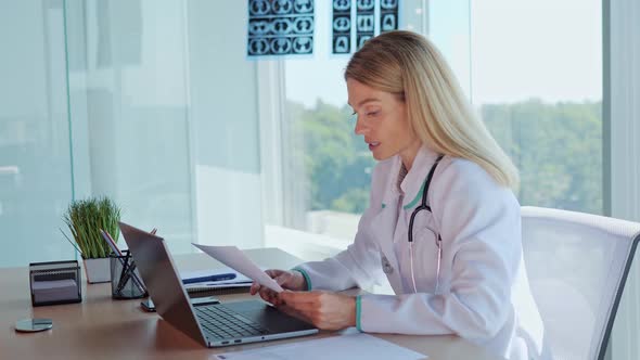 Doctor Make Online Video Call Reads the Statement Consult Patient on Laptop