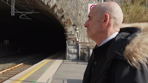 Old Man Waiting for the Train on the Platform