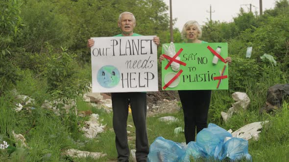 Senior Volunteers with Protesting Posters Our Planet Needs Help, Say No To Plastic. Nature Pollution