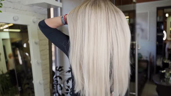 Very Long Blond Hair in a Young Beautiful Woman in a Hairdressing Salon