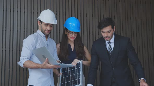 Team engineer planning and examining blueprint and laptop computer with checking panel energy.