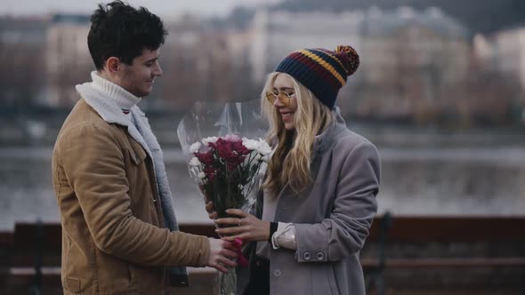 Handsome Guy Mading Date with Pretty Blonde on River Embankment on Summer Spring or Autumn Day