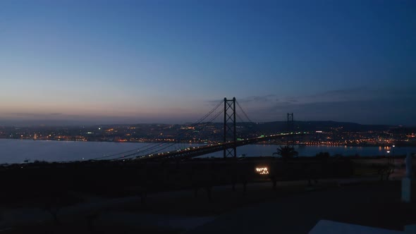 Gradually Revealing Aerial Panorama of Cablestayed Bridge After Sunset