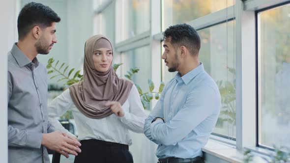 Three Diverse Professional Colleagues Talking in Modern Office Happy Friendly Arab Muslim Woman in