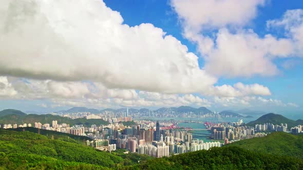 Aerial Hyperlapse of Kowloon, Hong Kong. From Mountain to Hong Kong.Blue sky moving clouds