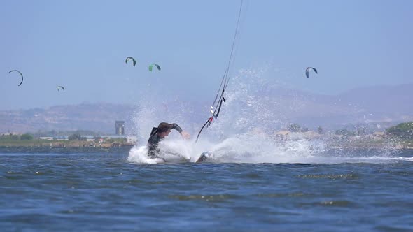 A man crashes while kiteboarding on a kite board