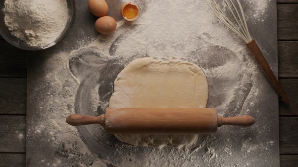 Magic concept - a rolling pin itself rolls out the dough.