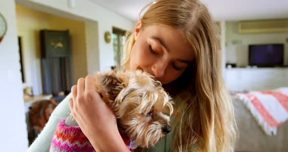 Woman holding her dog at home 4k