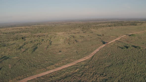 4 wheel drive vehicle on wildlife safari in Kenya. Aerial drone view of safari holiday