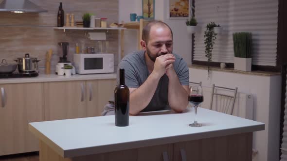 Sad Husband Drinking in the Kitchen