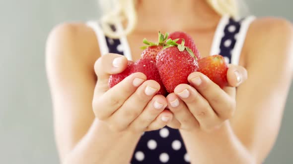 Close-up of woman holding strawberries