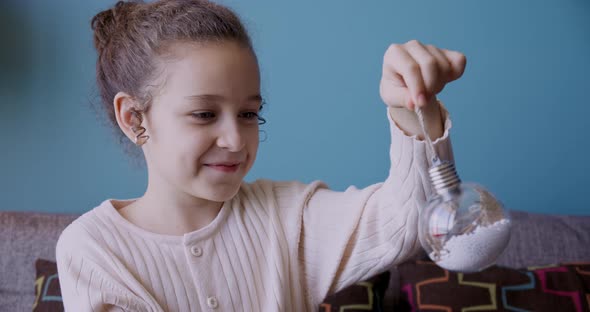 Portrait Funny Little Girl Smiling Child Looking at a Toy Ball are Sitting on Couch at Home Cute Kid