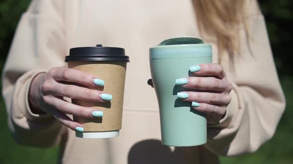 Close Up Girl Holding Two Cup Eco Friendly Reusable and Paper Coffee Disposable