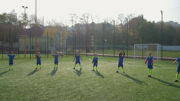 Kids Soccer Team During Warm Up on Football Field