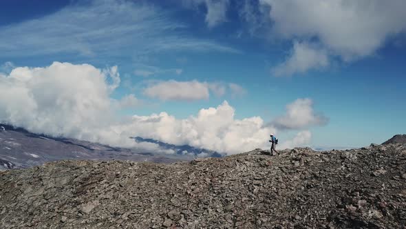 Man Walking on a Rocky Ridge in a Big Mountains Training