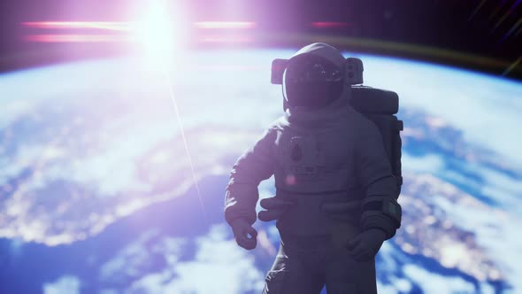 Space Man Astronaut in Space on a Background of the Blue Planet Earth