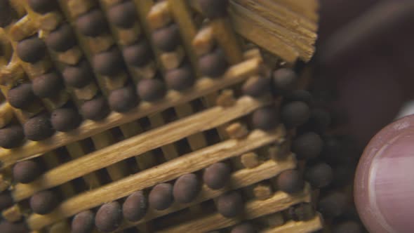 Person Shows House Made From Matches on Light Background