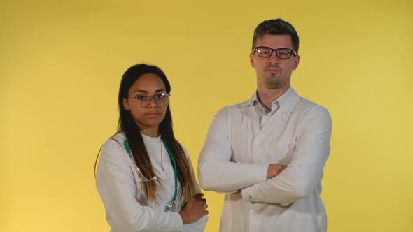 Mixed-race Male and Female Doctors Denying Something To the Camera