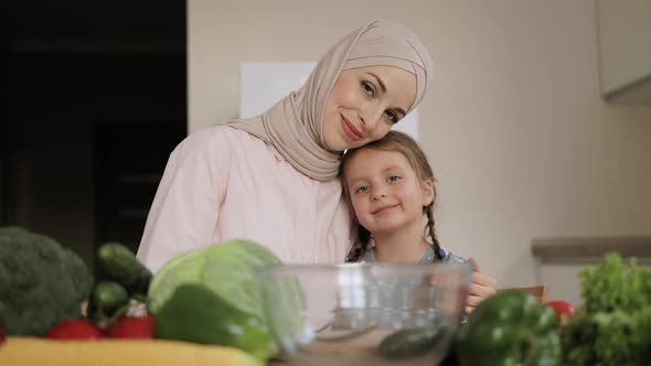 Muslim Mother and Child Daughter are Preparing Proper Meal with Vegetables