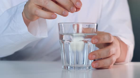 Woman Drop Effervescent Tablet in Glass