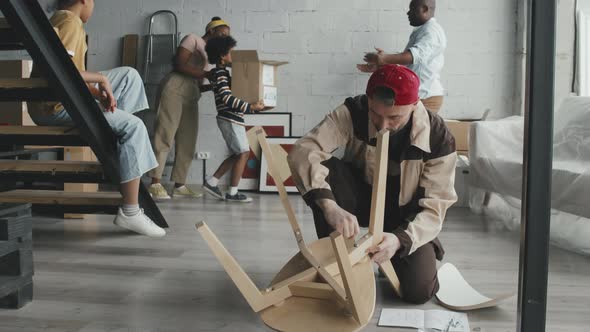 Worker Assembling Furniture for New Homeowners