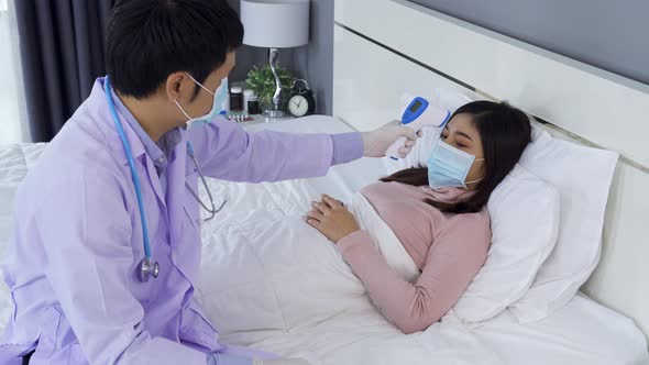 doctor using infrared forehead thermometer (thermometer gun) to measuring temperature of sick woman
