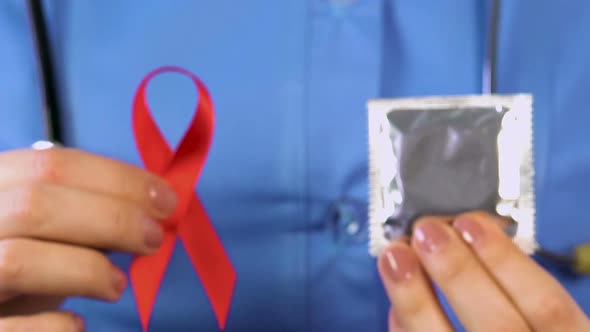 Nurse Giving People Condoms and Red Ribbons Social Campaign Against HIV and AIDS