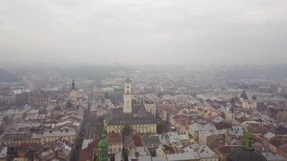 Aerial: Cityscape of Lviv in misty weather